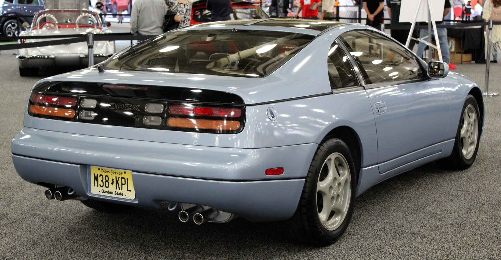 Rear view with distinct taillights, dual exhaust, and coupe design