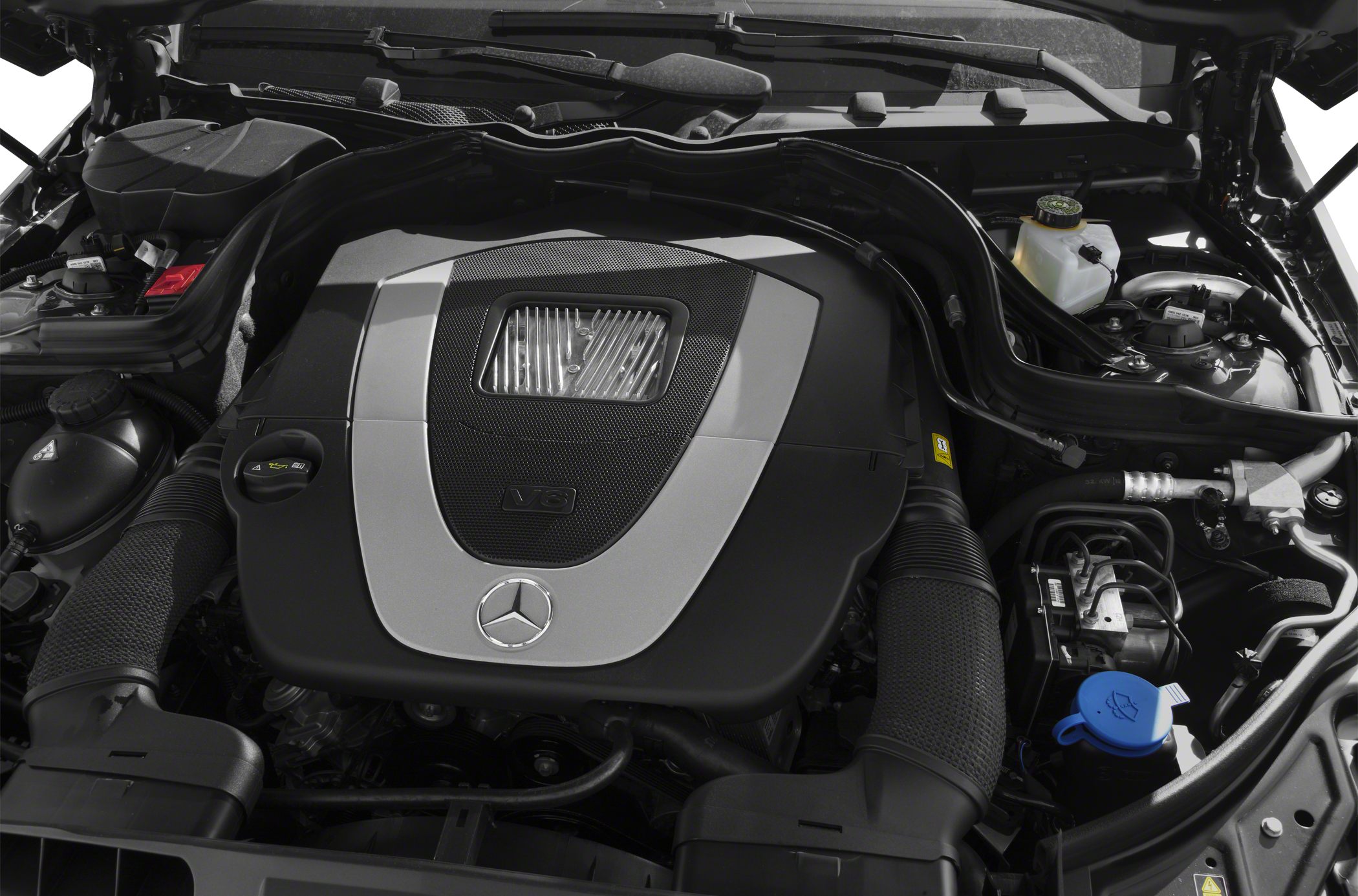 V6 engine with detailed engine bay components and Mercedes emblem.