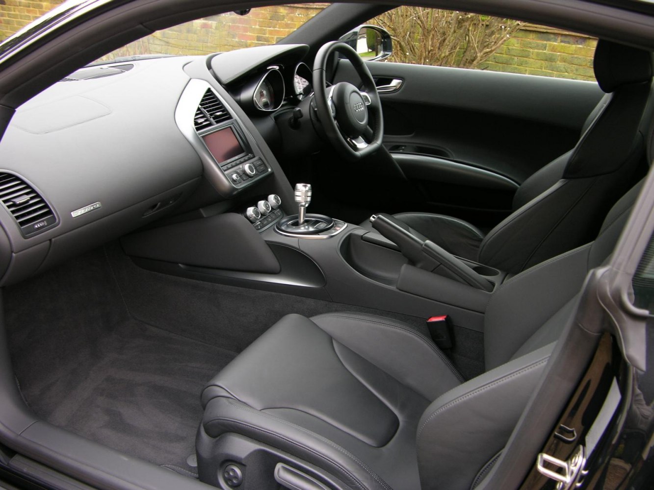 Luxury sports car interior with leather seats and modern dashboard controls