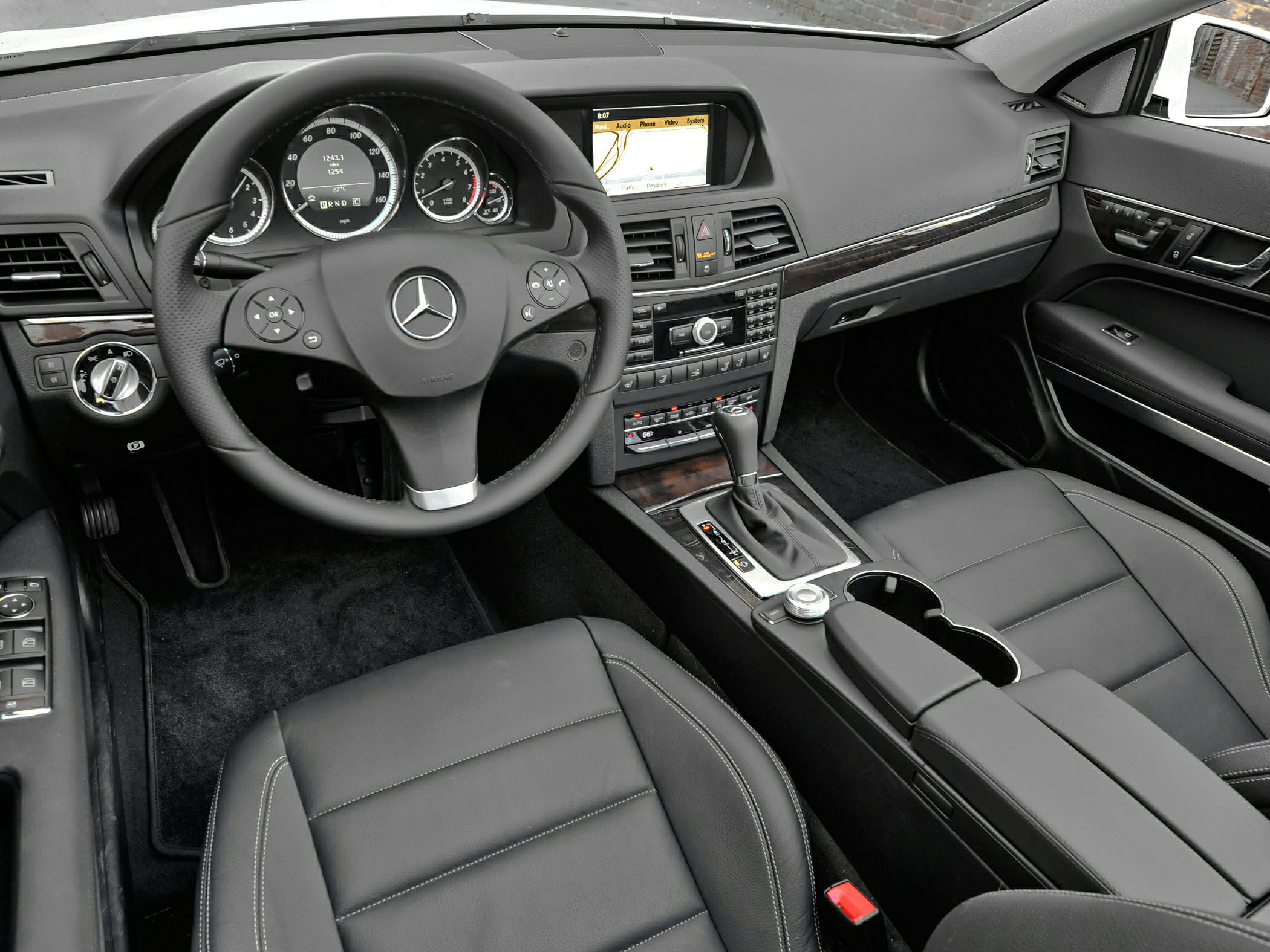 Multi-function steering wheel and infotainment dashboard in luxury interior