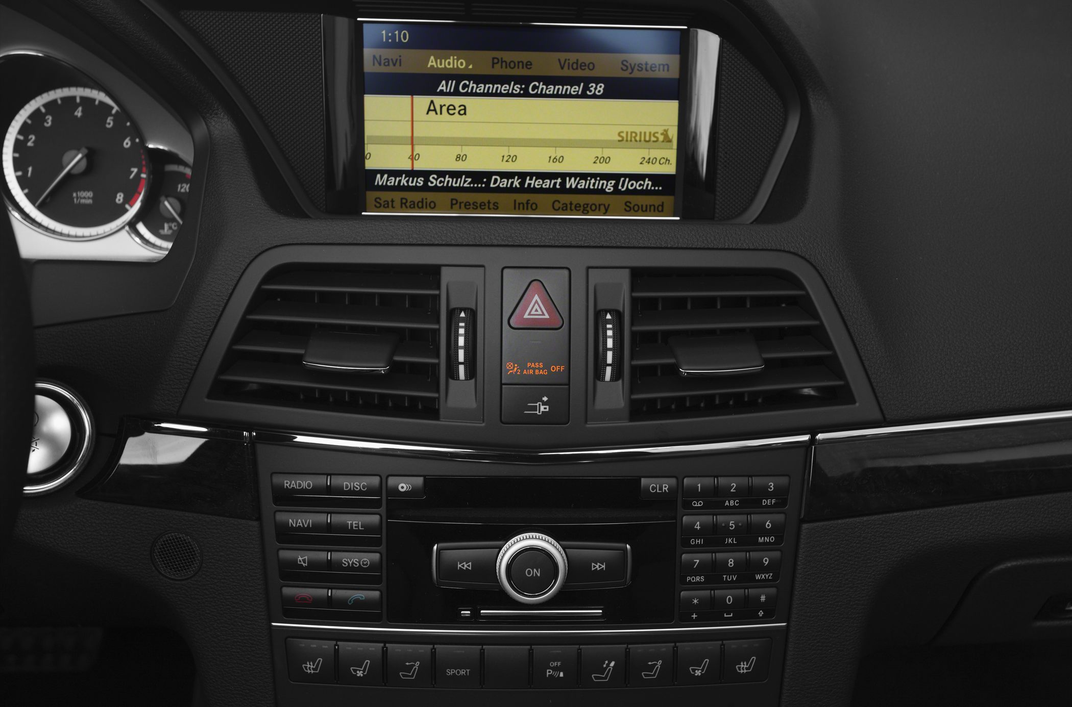 Central infotainment screen and control panel with multimedia buttons and climate controls