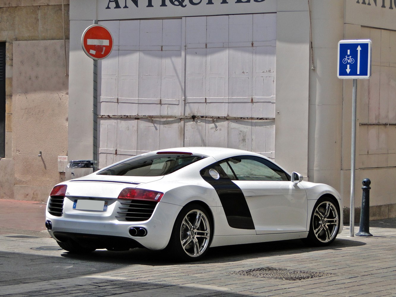 White sports coupe with black sideblade and distinctive rear lights