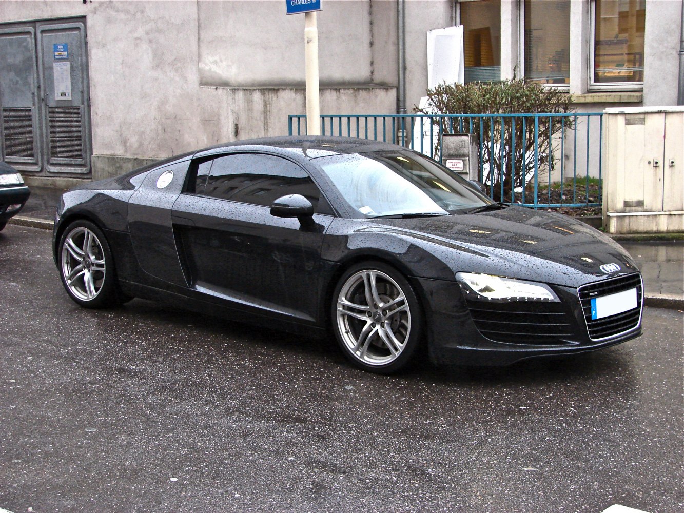 Sleek side profile with LED headlights and alloy wheels in wet conditions