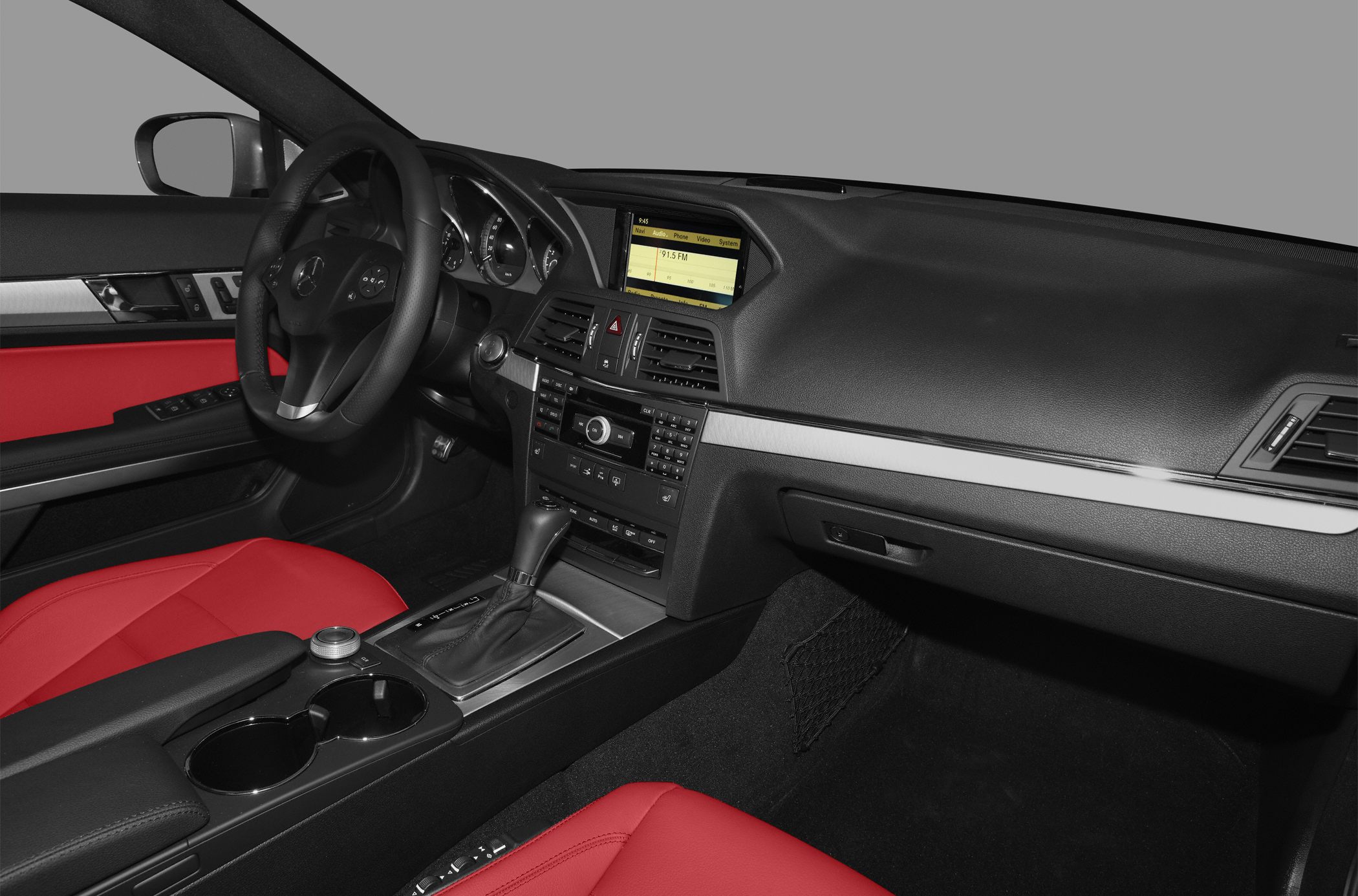 Dashboard with infotainment and red leather seats