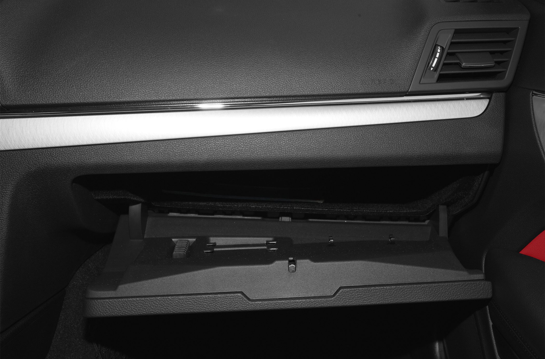 Open glove box and dashboard trim with air vent