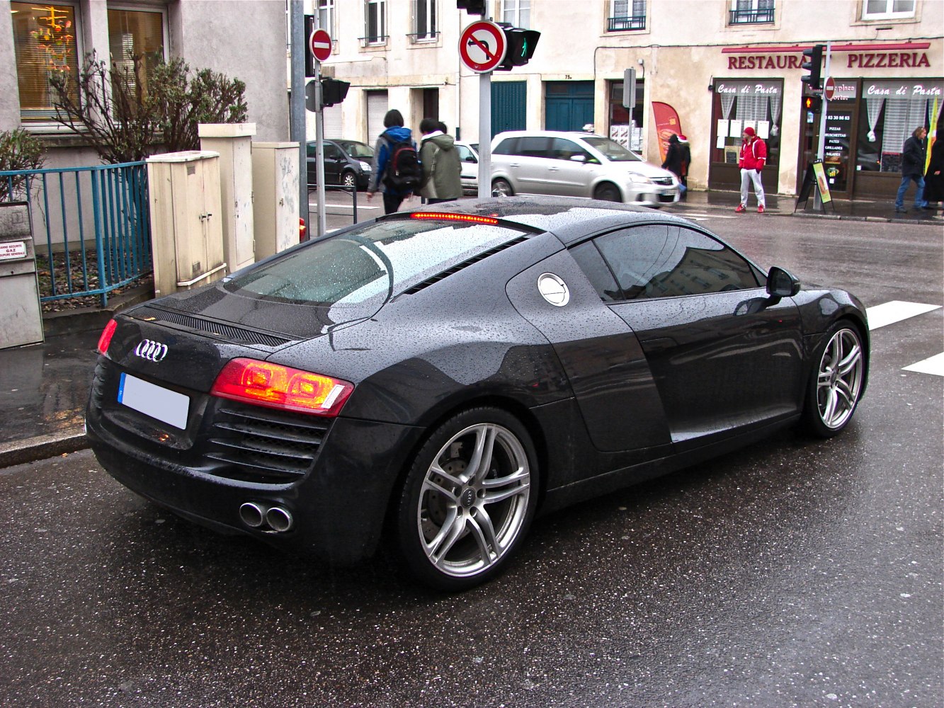 Rear view of sleek coupe with LED taillights and dual exhausts