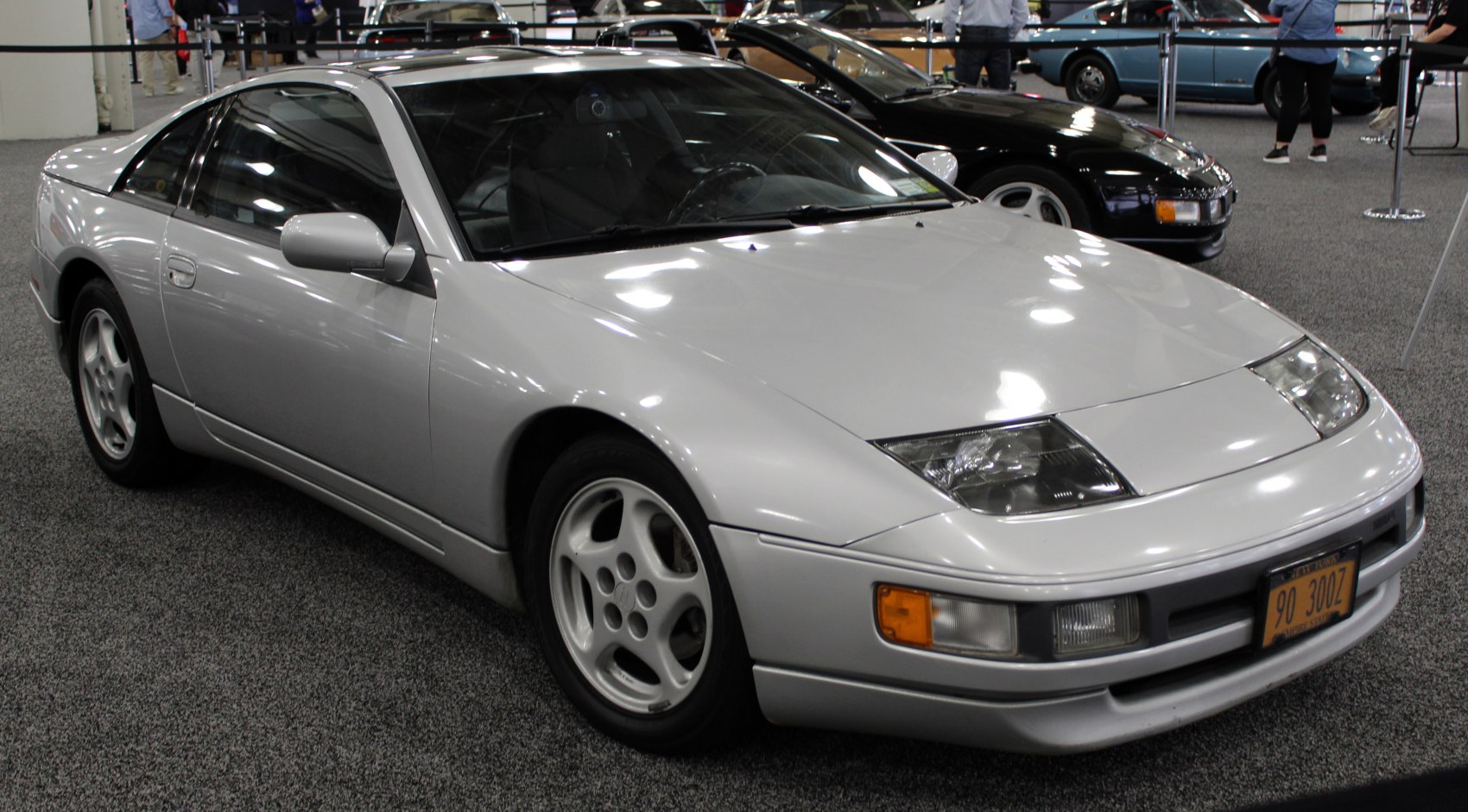 Silver sports coupe with pop-up headlights and aerodynamic body design