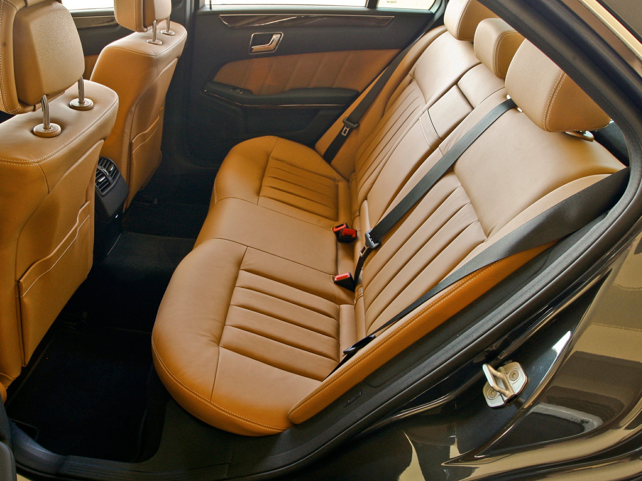 Brown leather rear seats with seat belts and door panel