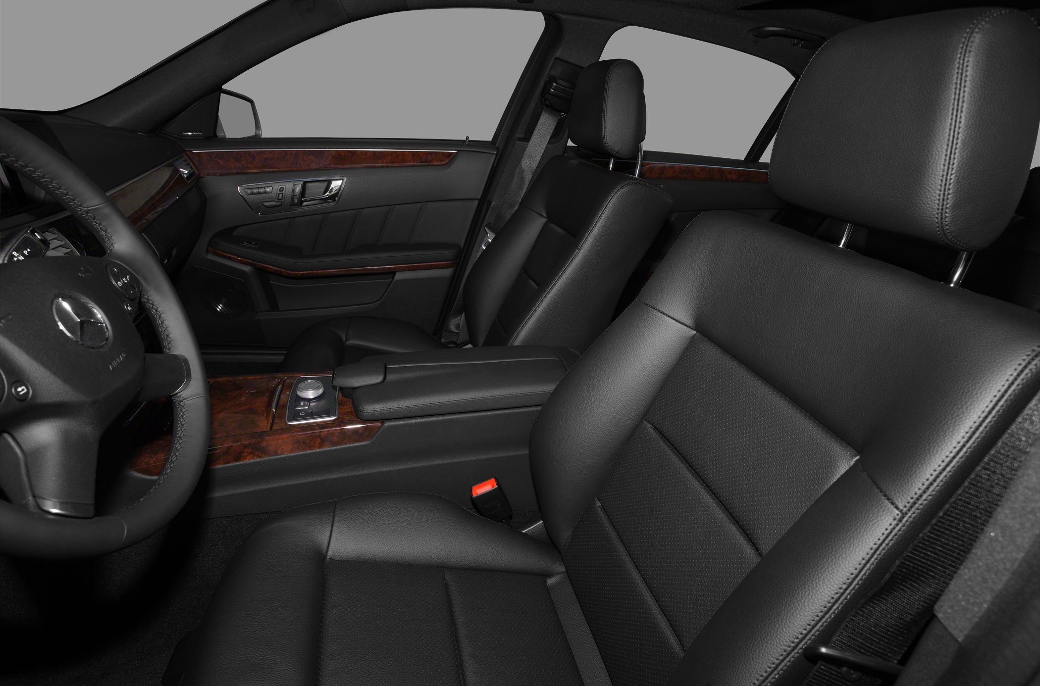 Black leather seats and wood trim interior with detailed controls