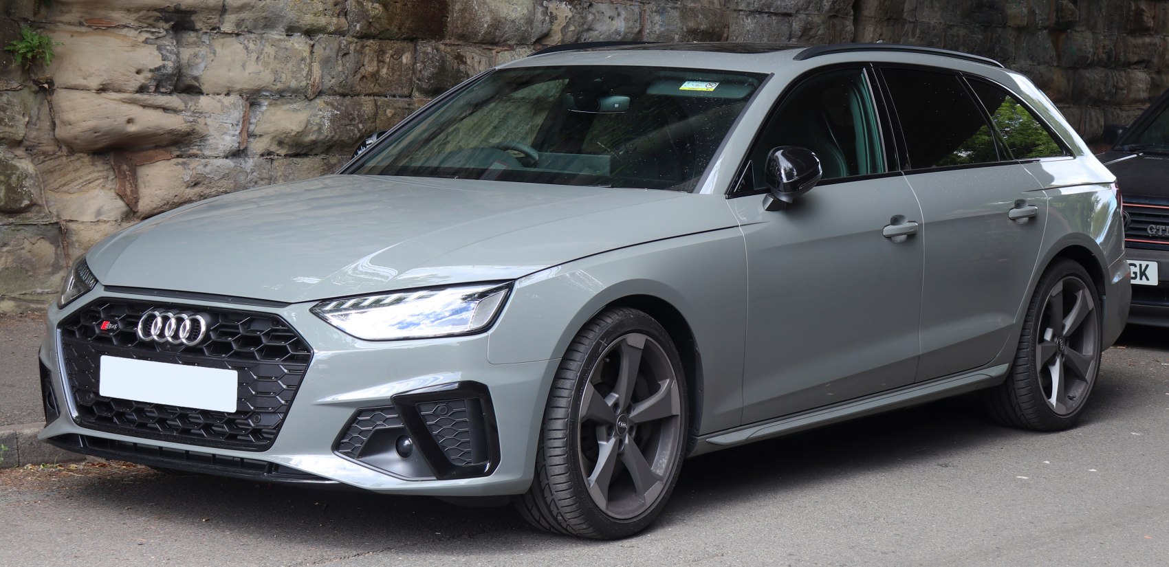 Front-side view with sharp LED headlights and honeycomb grille