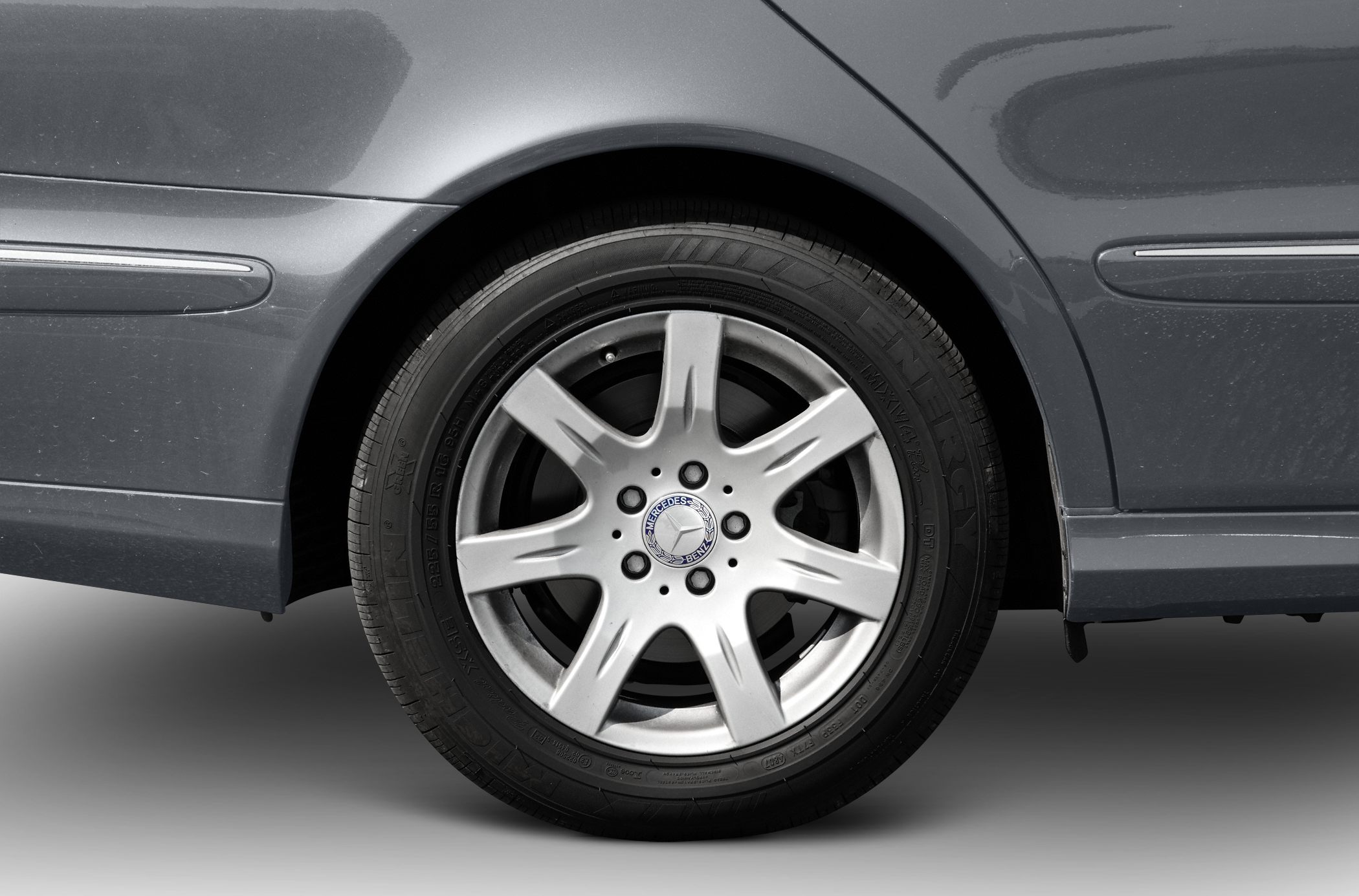 Silver alloy rear wheel and tire with Mercedes-Benz emblem