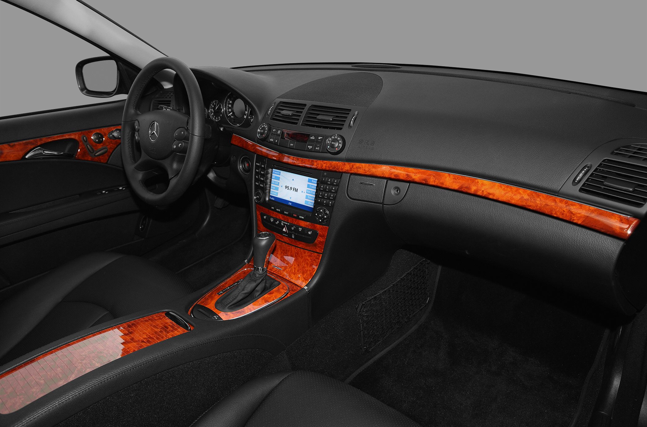 Wood trim dashboard with black leather interior and infotainment system