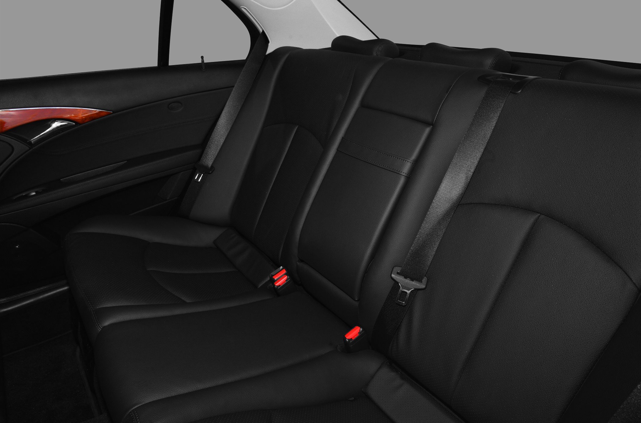Black leather rear seats with safety belts and wood trim