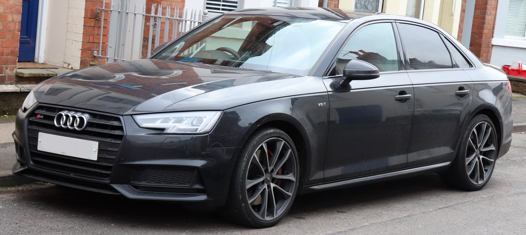 Front-side view of sedan with LED headlights and sporty alloy wheels