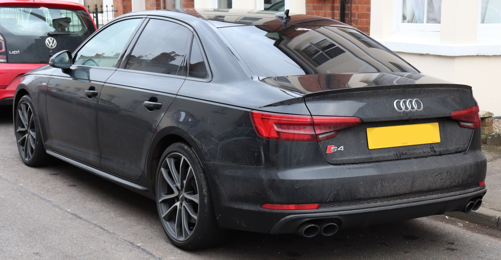 Rear view with dual exhausts and sporty alloy wheels, tinted windows