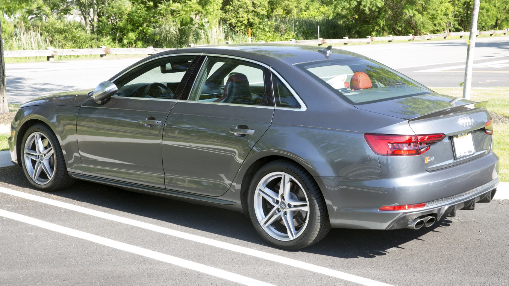 Side and rear view with alloy wheels and quad exhaust