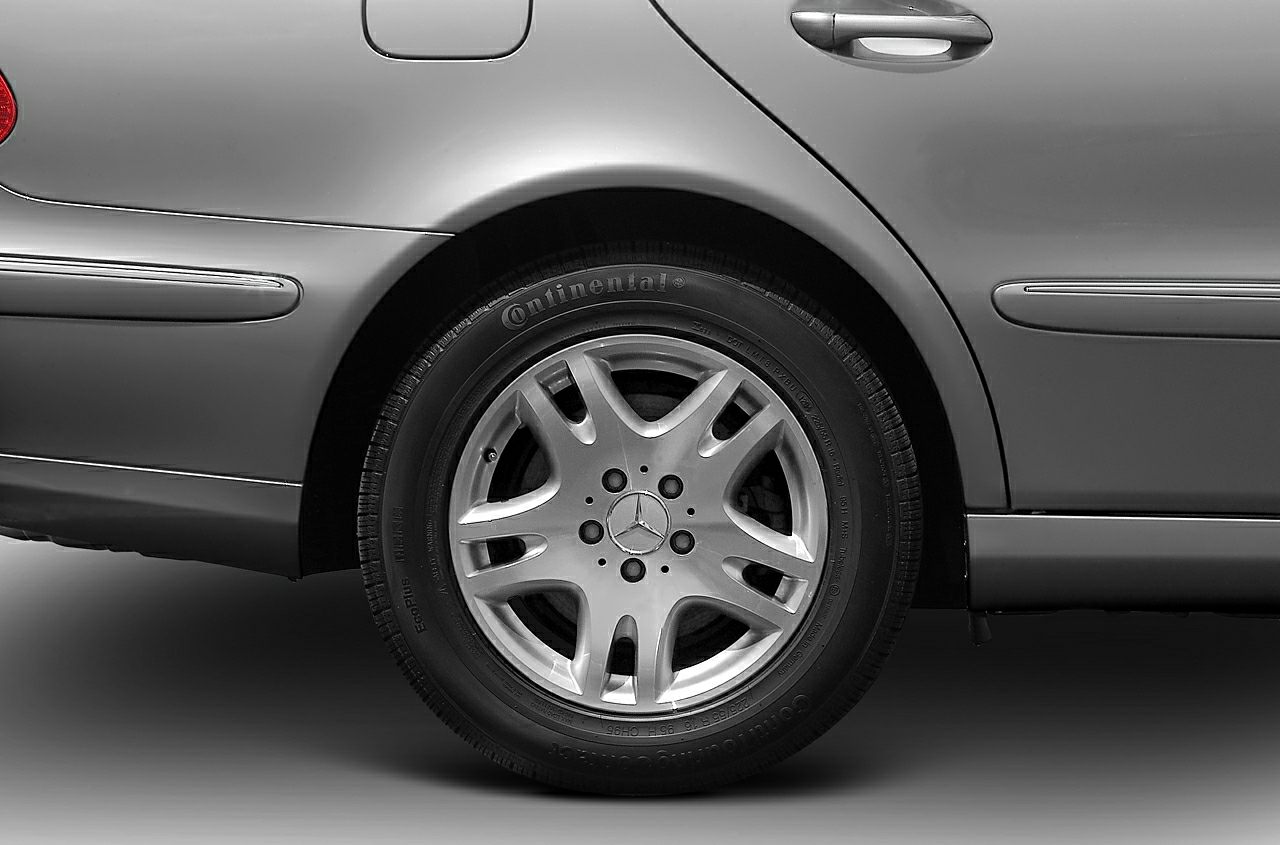 Close-up of a rear alloy wheel and side door panel.