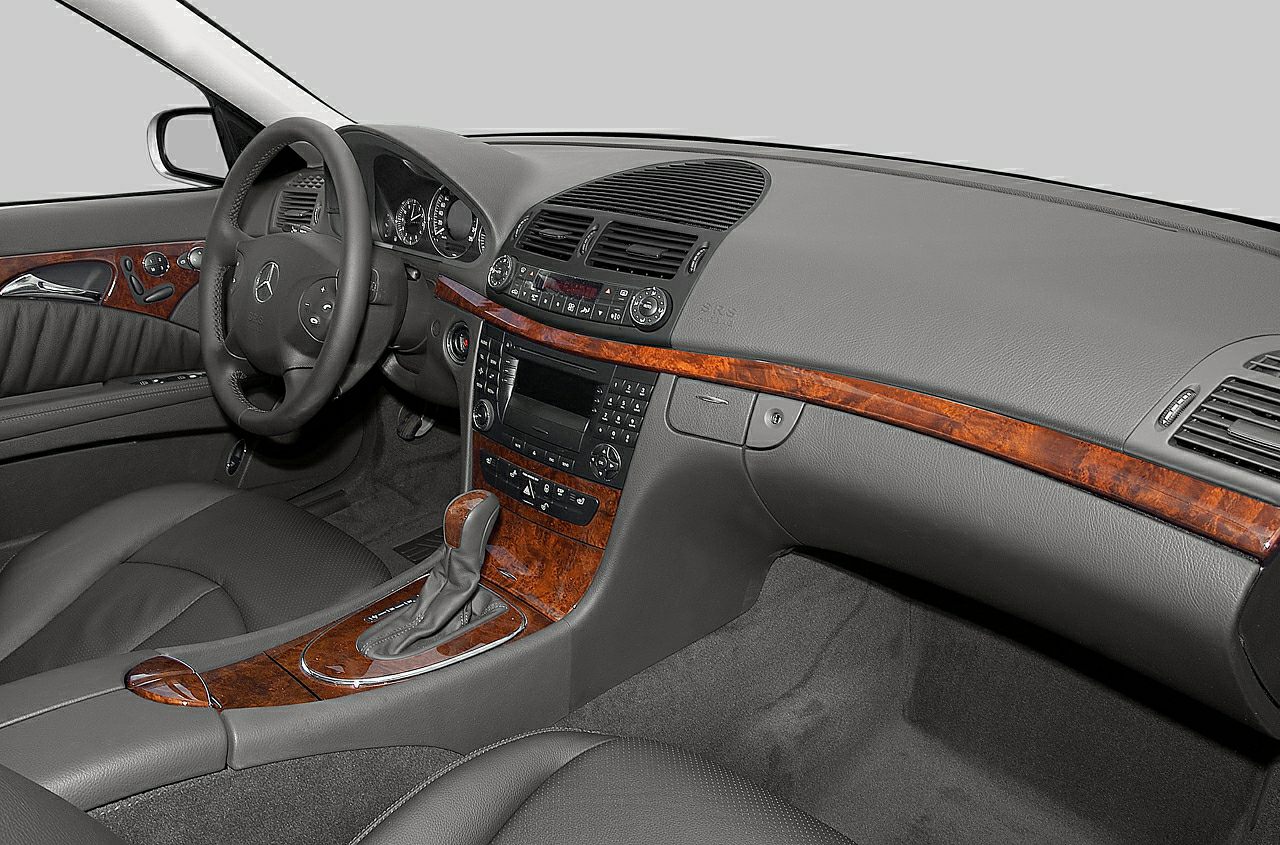Wood-trimmed dashboard and leather seats with classic control layout
