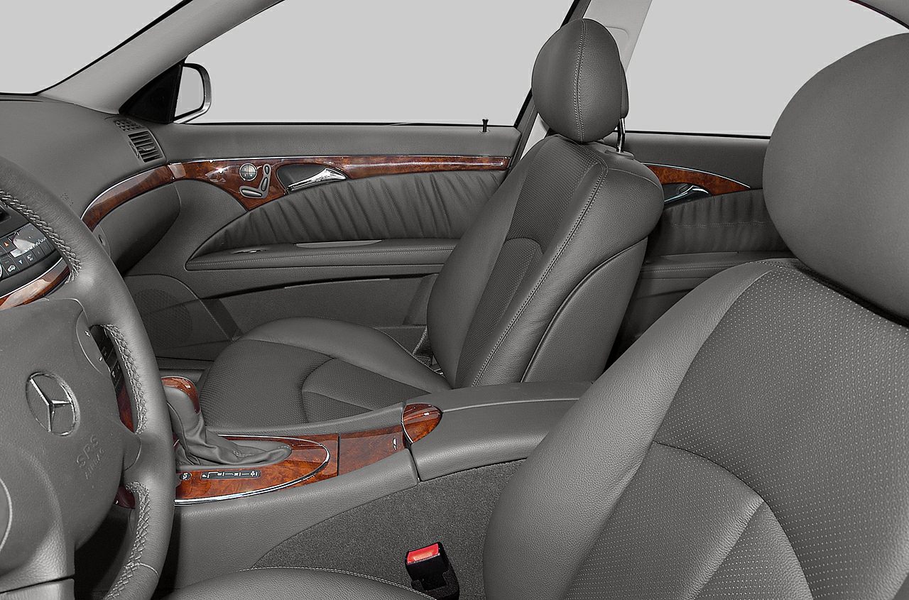 Gray leather seats with elegant wood trim in luxury car interior