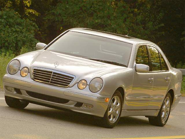 Silver sedan with quad round headlights and chrome grille