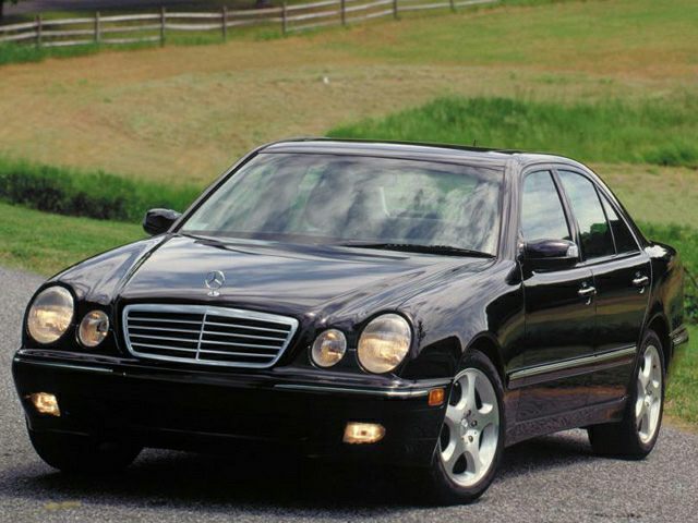 Front view of a sedan with dual round headlights and chrome grille
