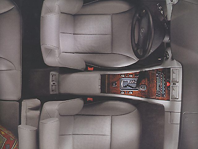 Top view of leather seats and wood-trimmed center console.