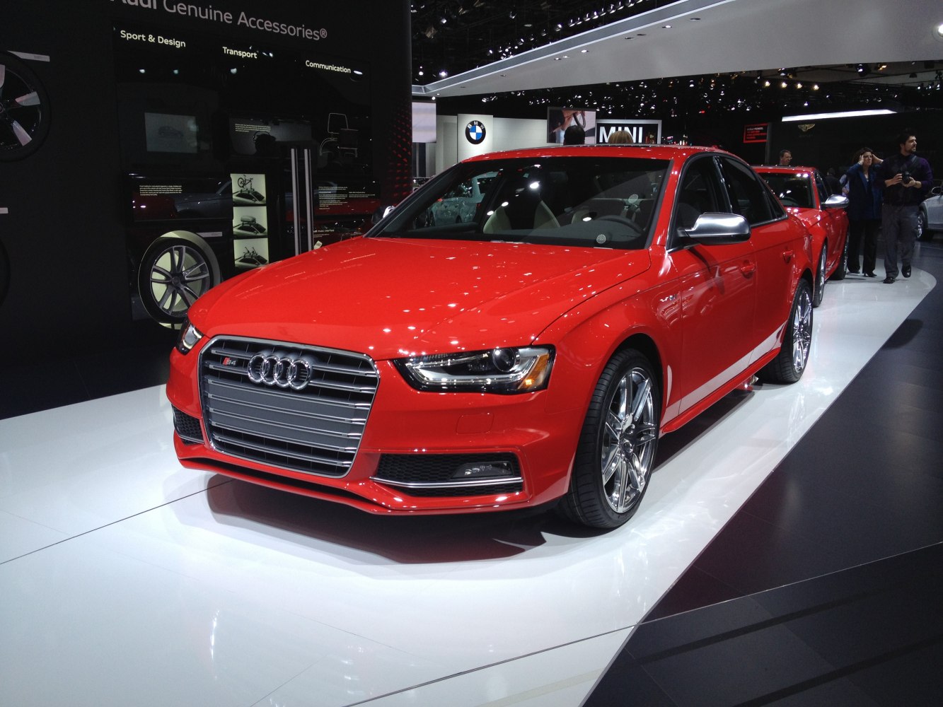 Red sedan with chrome wheels and large front grille