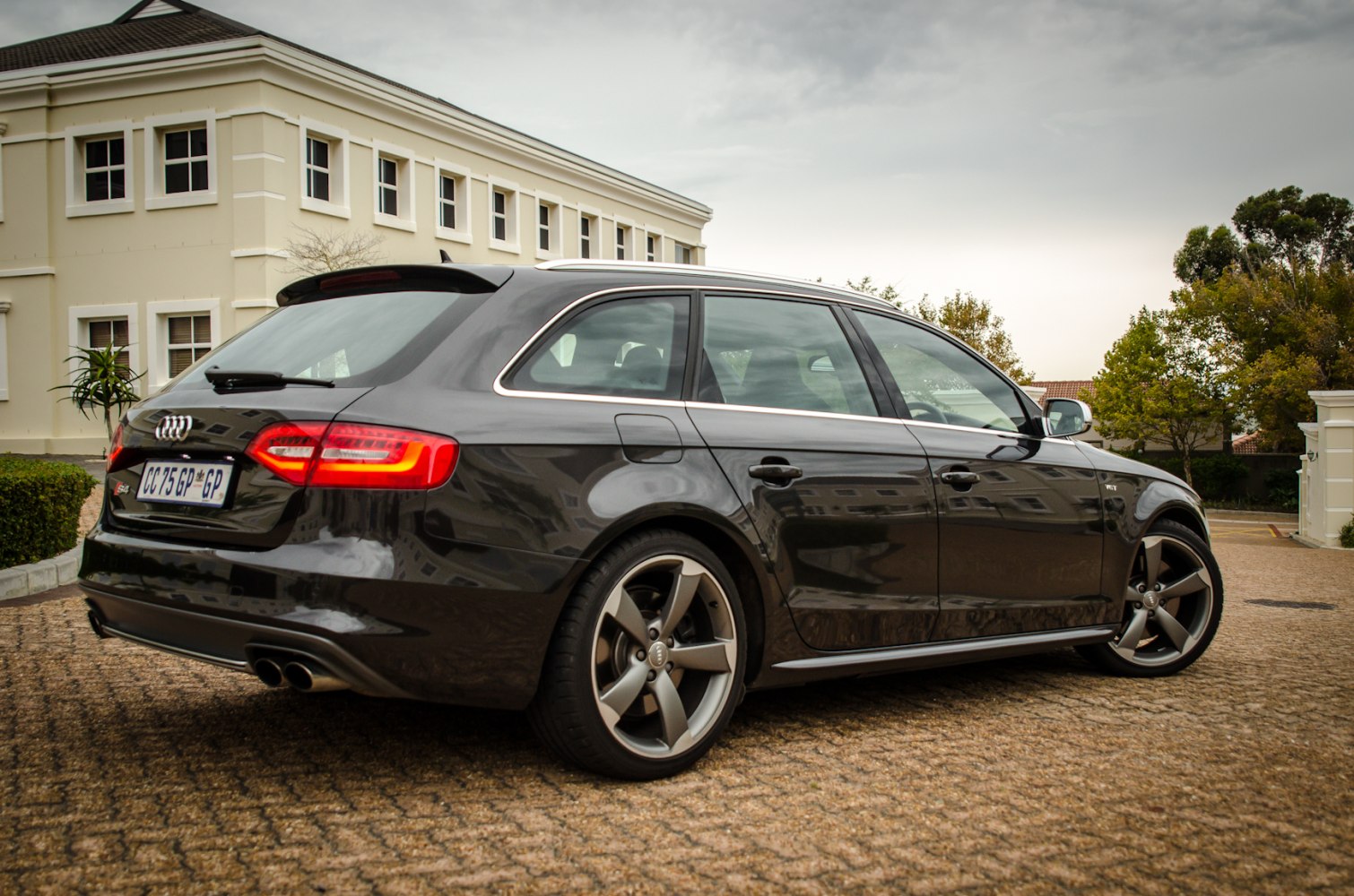 Rear side view of a sporty estate car with distinctive taillights and alloy wheels