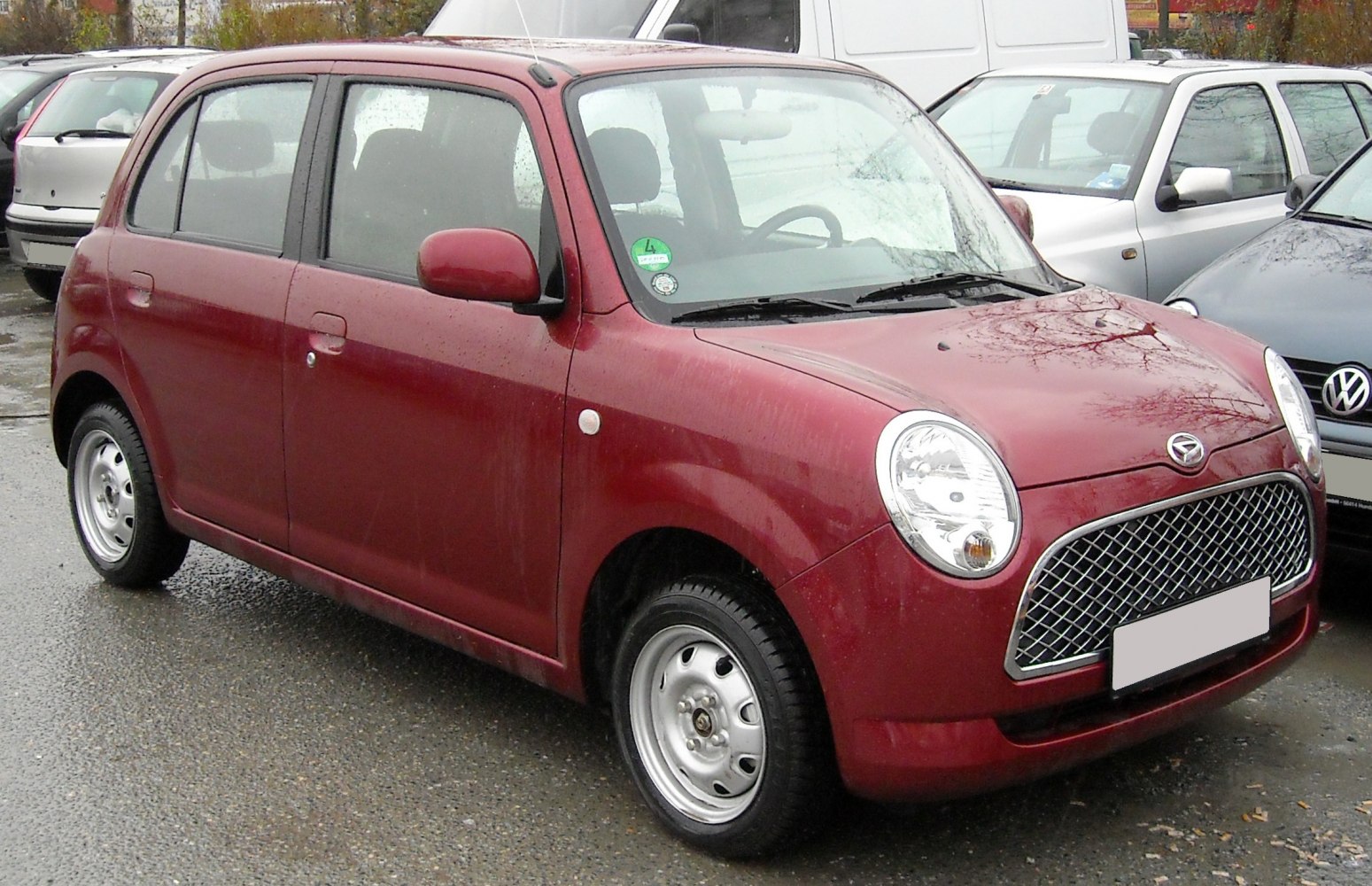 Compact hatchback with round headlights and mesh grille