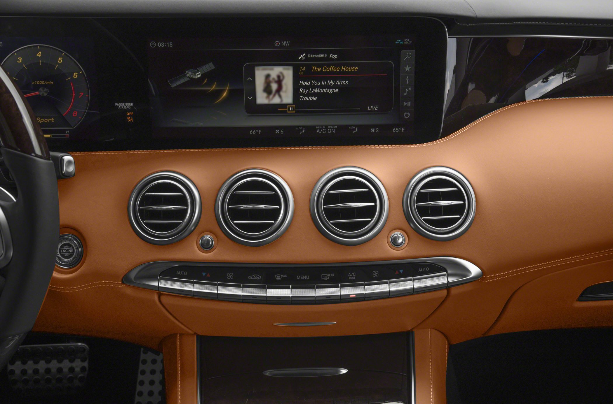 Dashboard with leather trim, circular air vents, and multimedia display