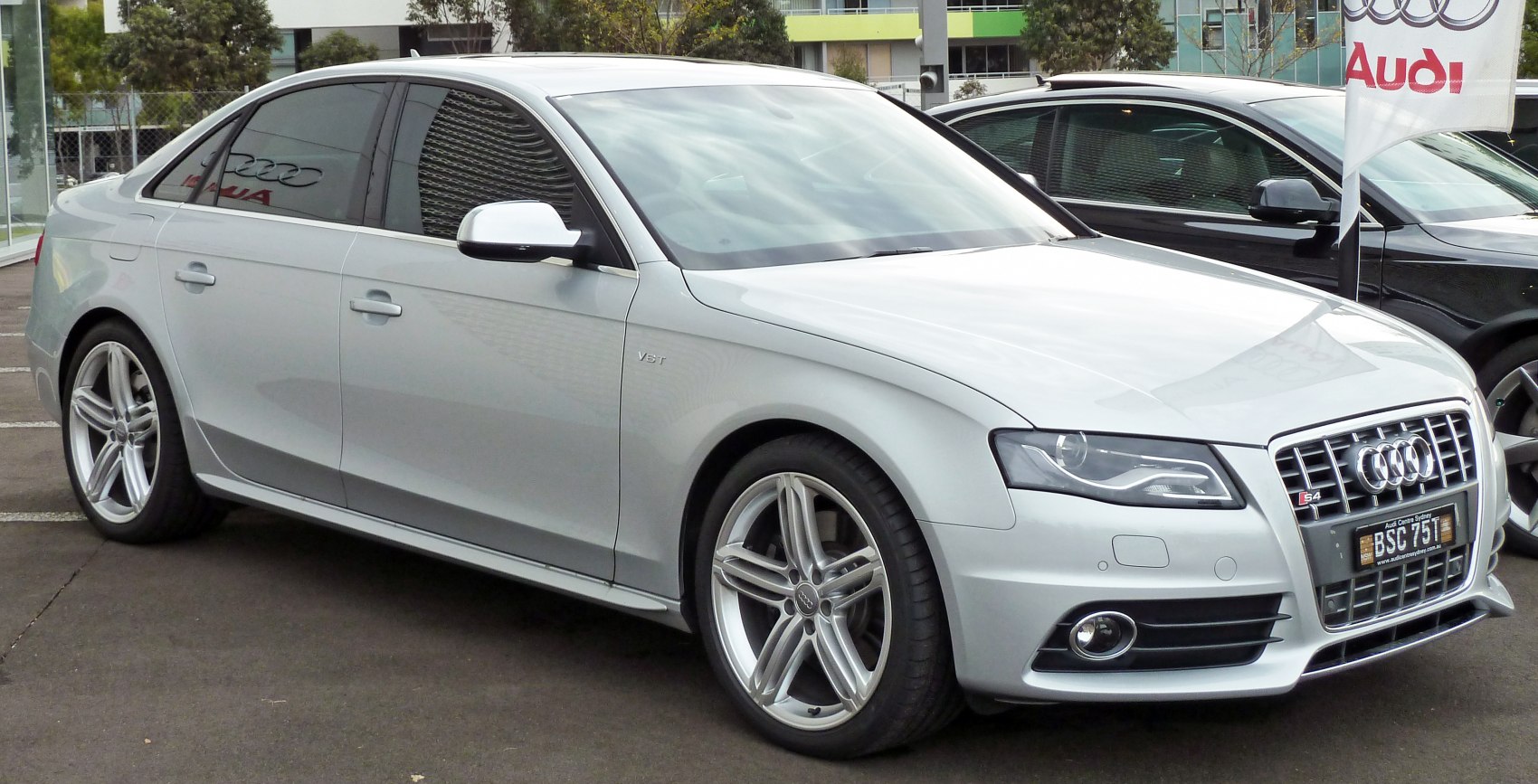Silver sedan with distinctive grille, headlights, and alloy wheels