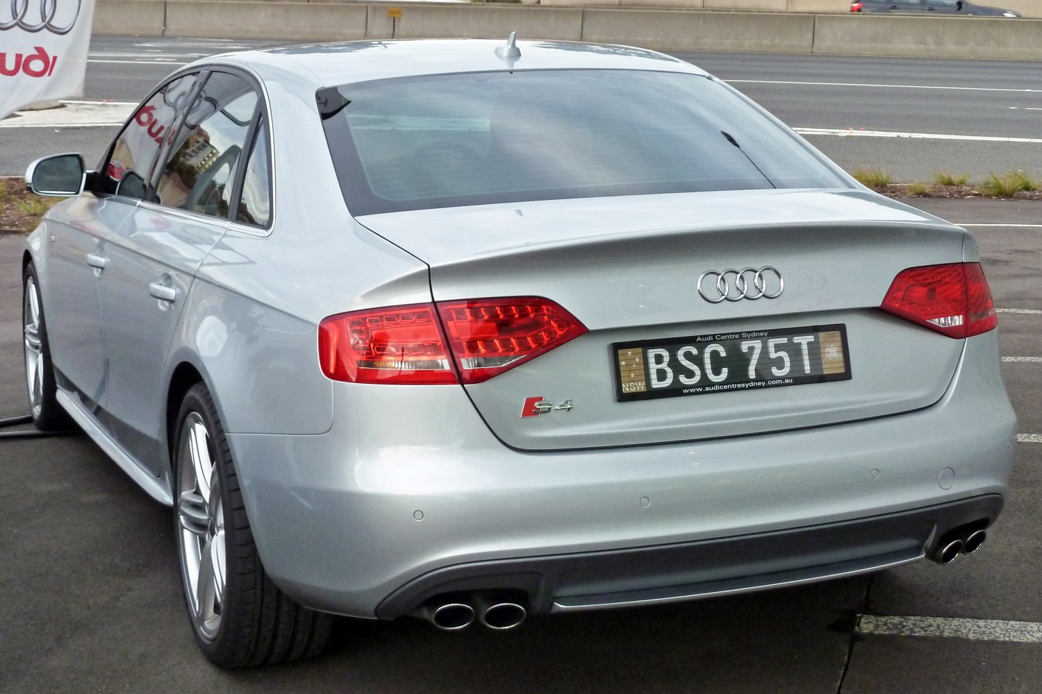 Rear of silver sedan with dual exhaust and LED taillights