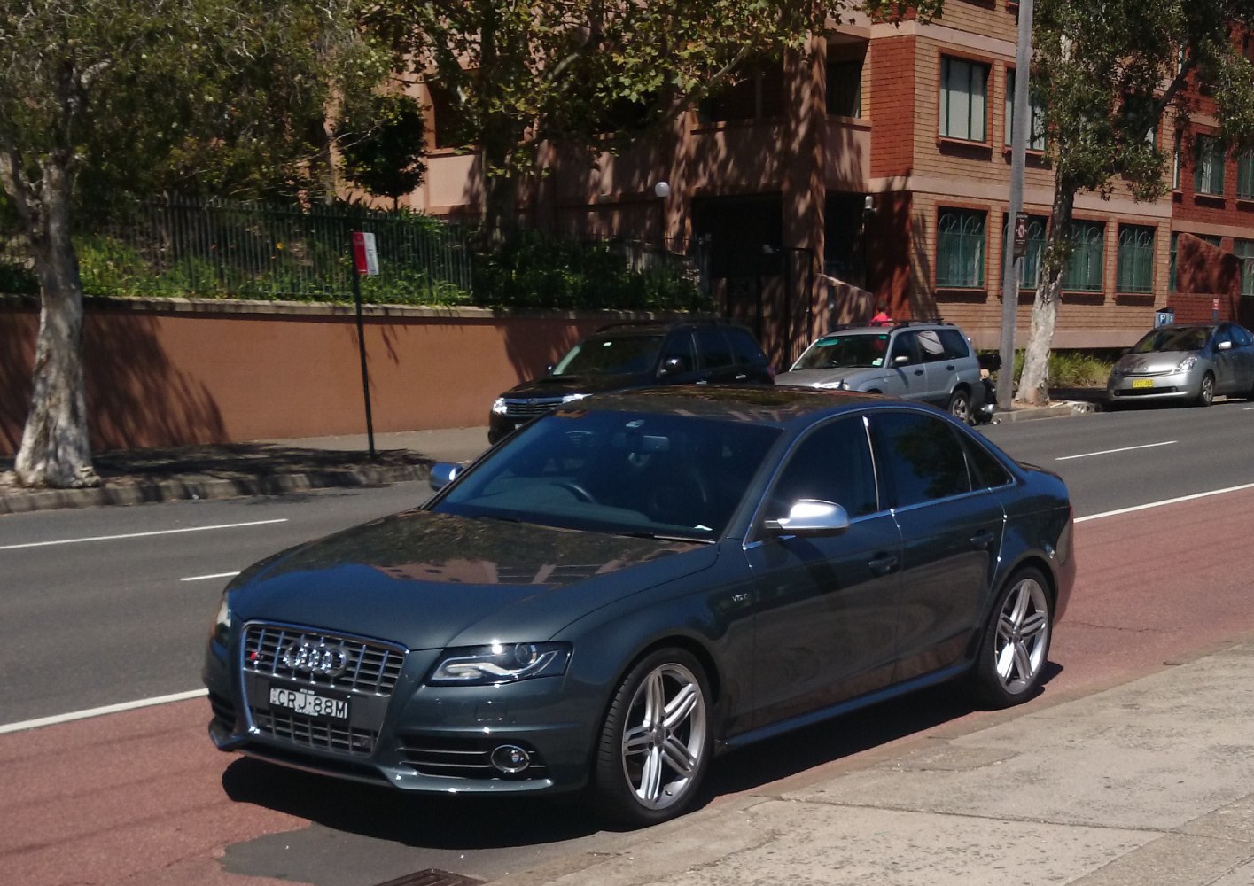 Sporty sedan front-side view with sharp headlights and alloy wheels