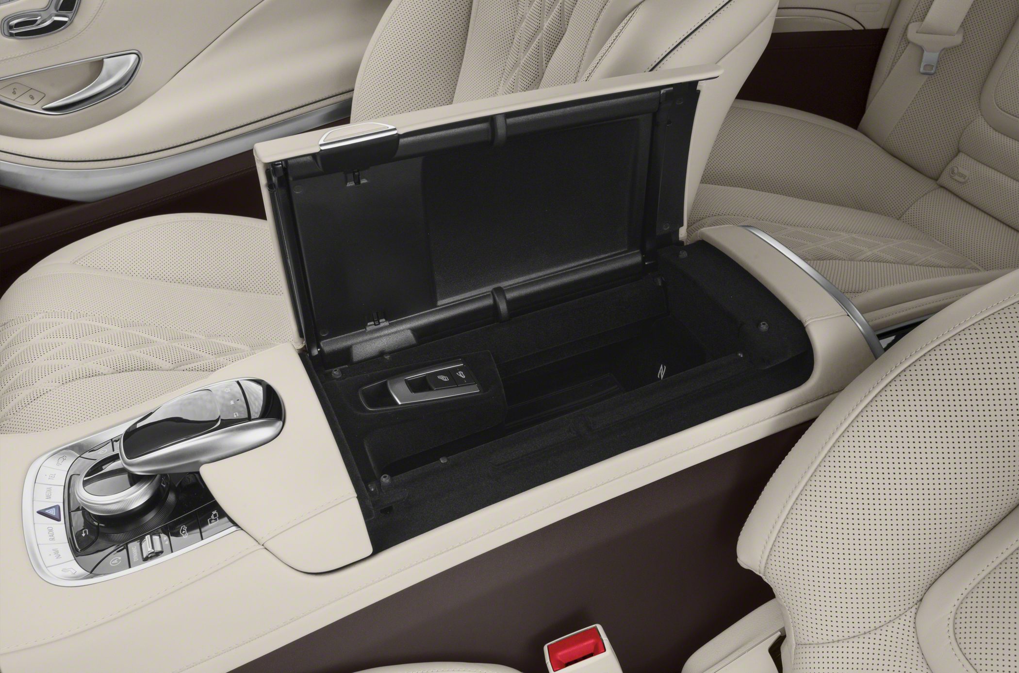 Beige leather center console with open storage compartment and control buttons