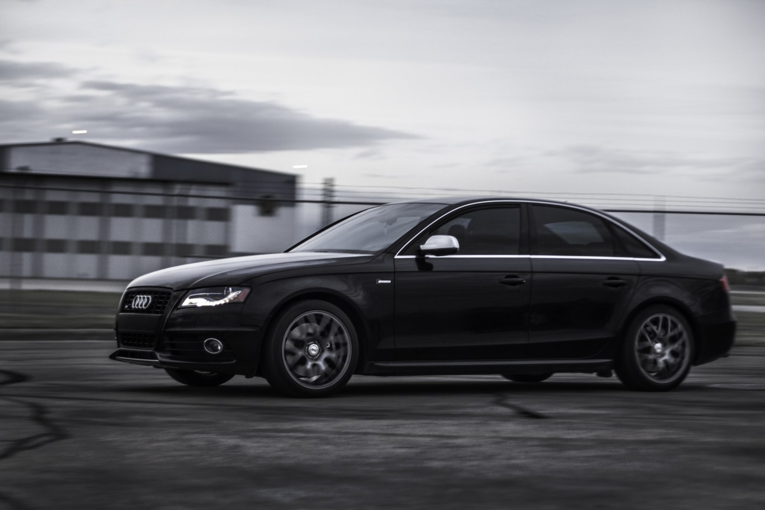 Side profile of a sedan with LED headlights and alloy wheels.
