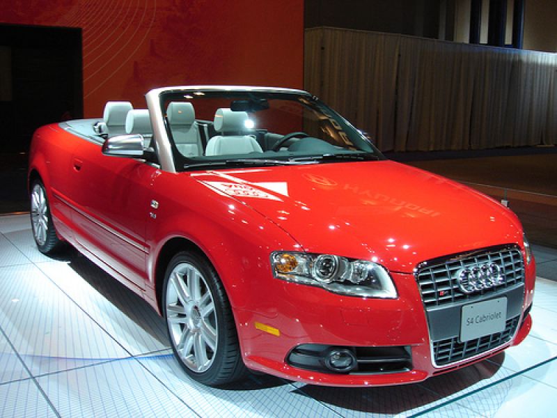 Red convertible with detailed front grille and alloy wheels