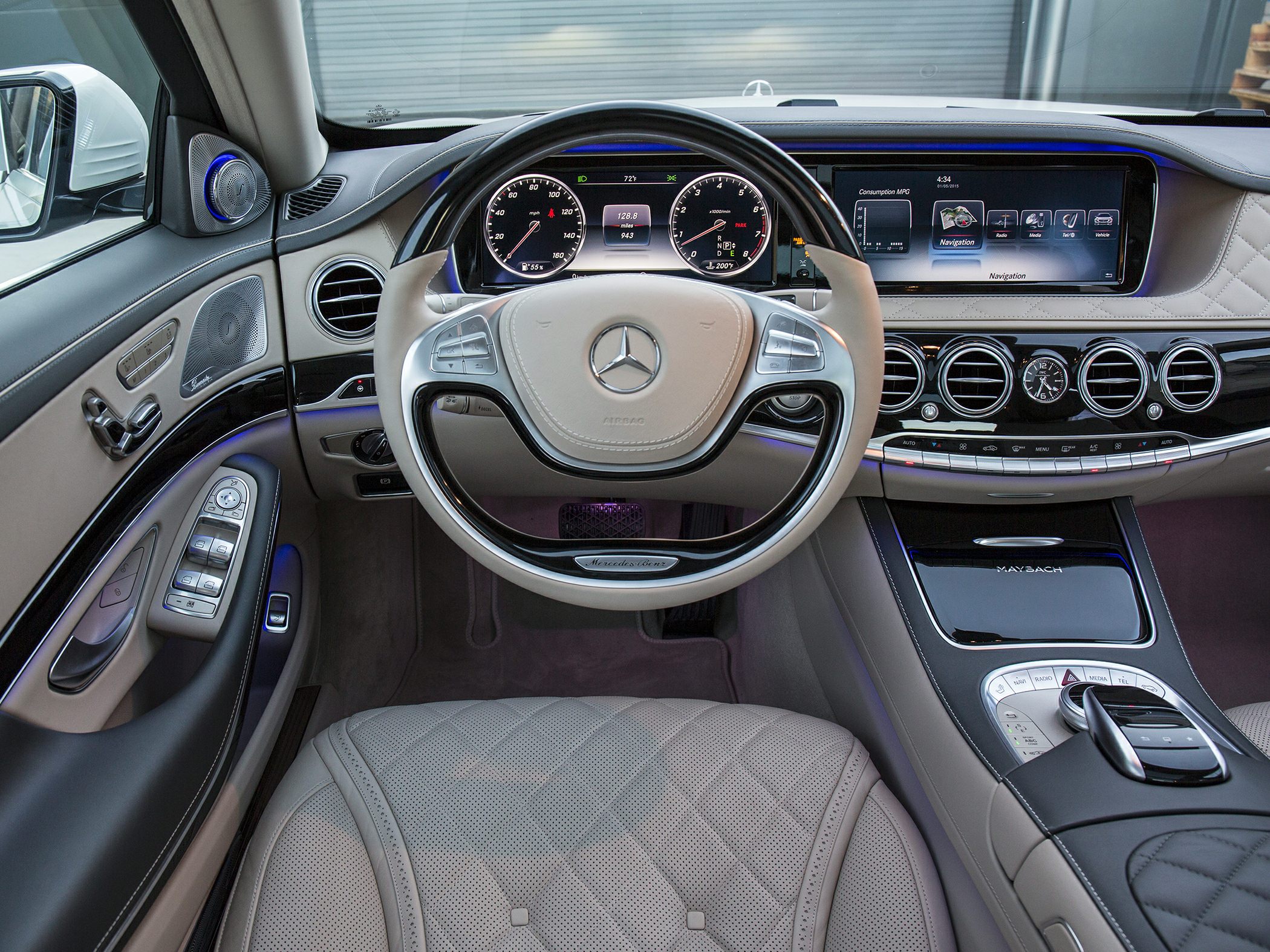Luxury steering wheel and digital dashboard with premium controls and ambient lighting.