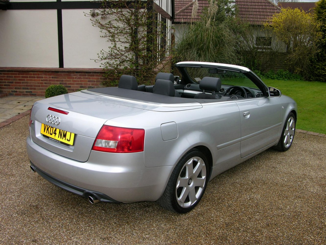 Silver convertible with rear view, dual exhaust, alloy wheels
