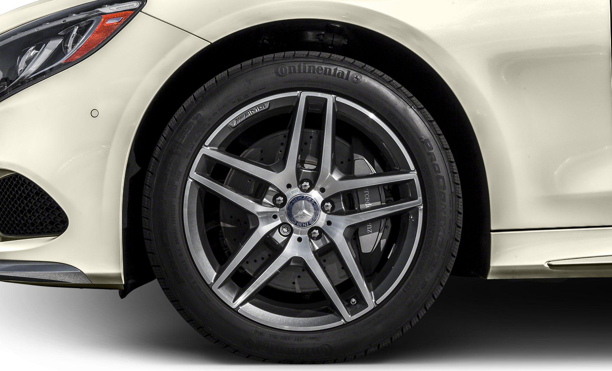 Close-up of AMG alloy wheel with perforated brake disc and Continental tire