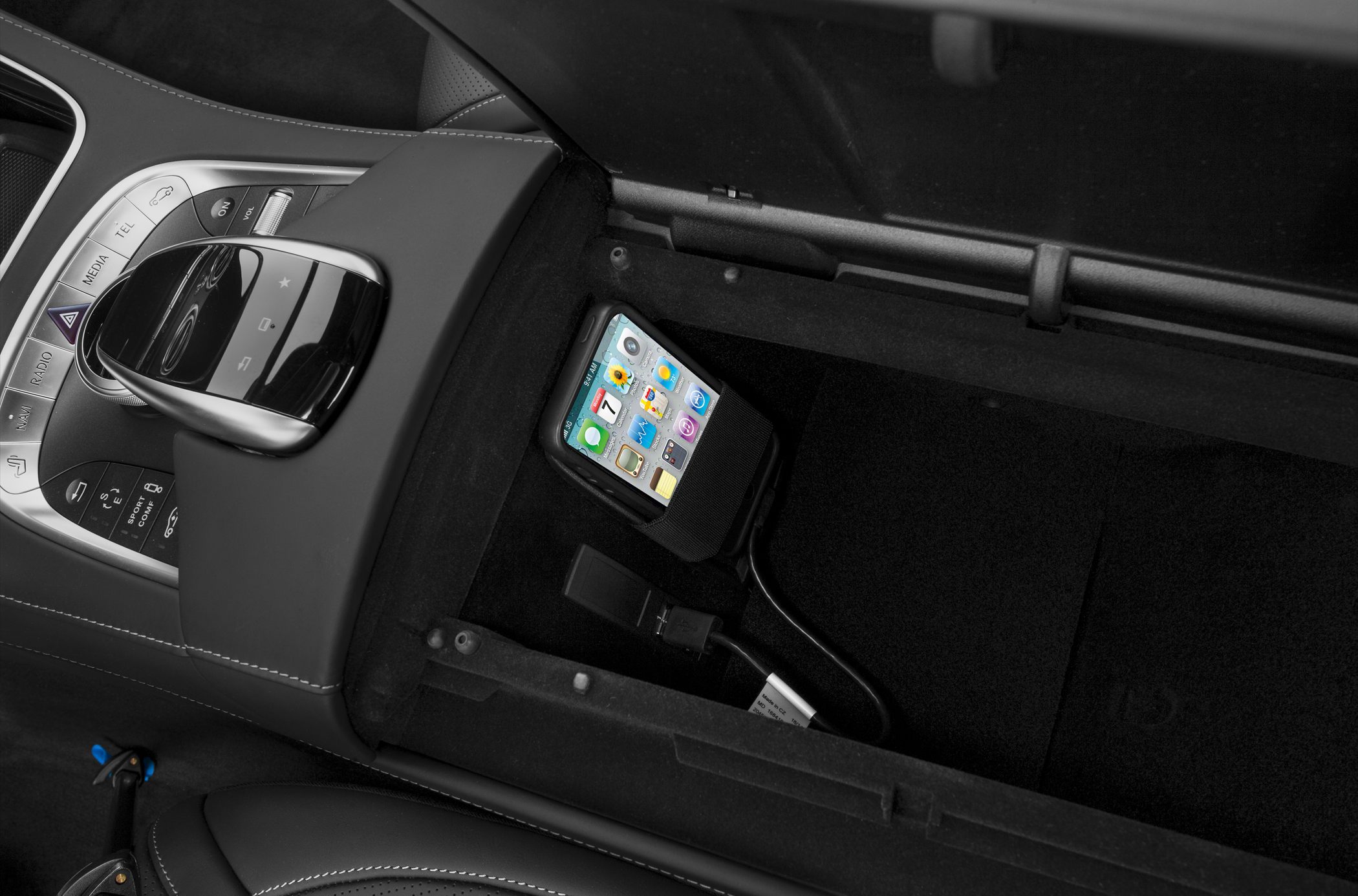 Center console with control panel and smartphone dock inside storage compartment
