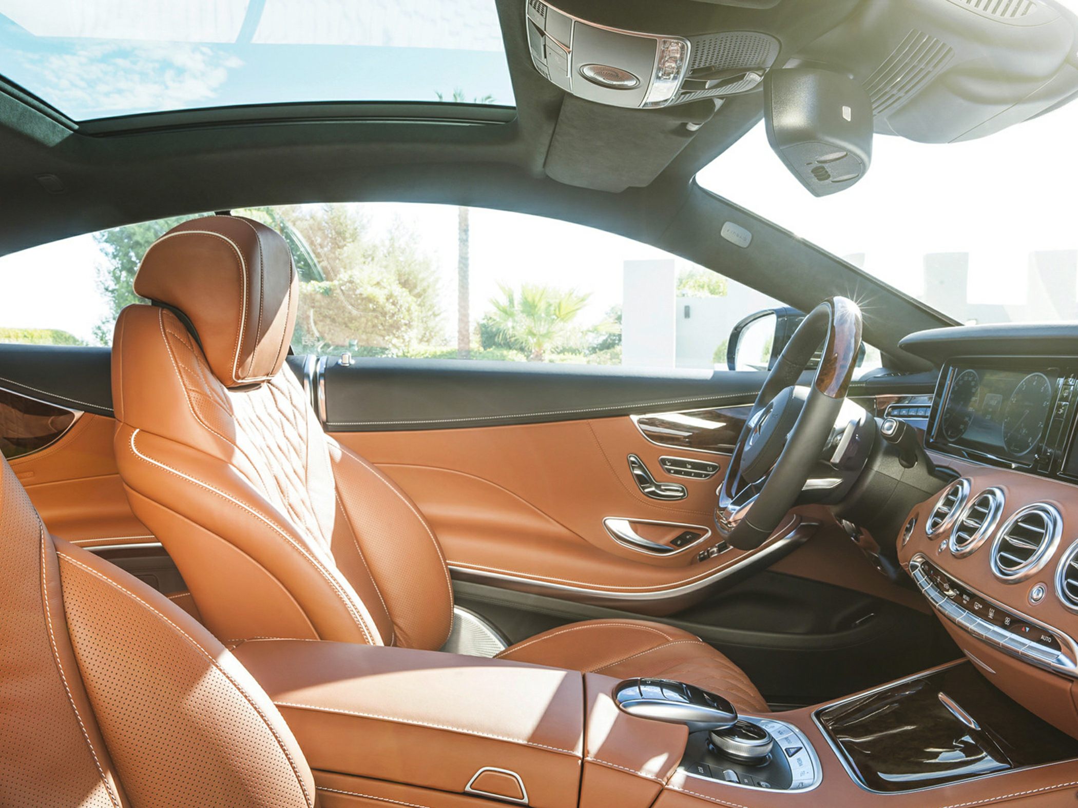 Panoramic sunroof and brown leather interior of luxury coupe