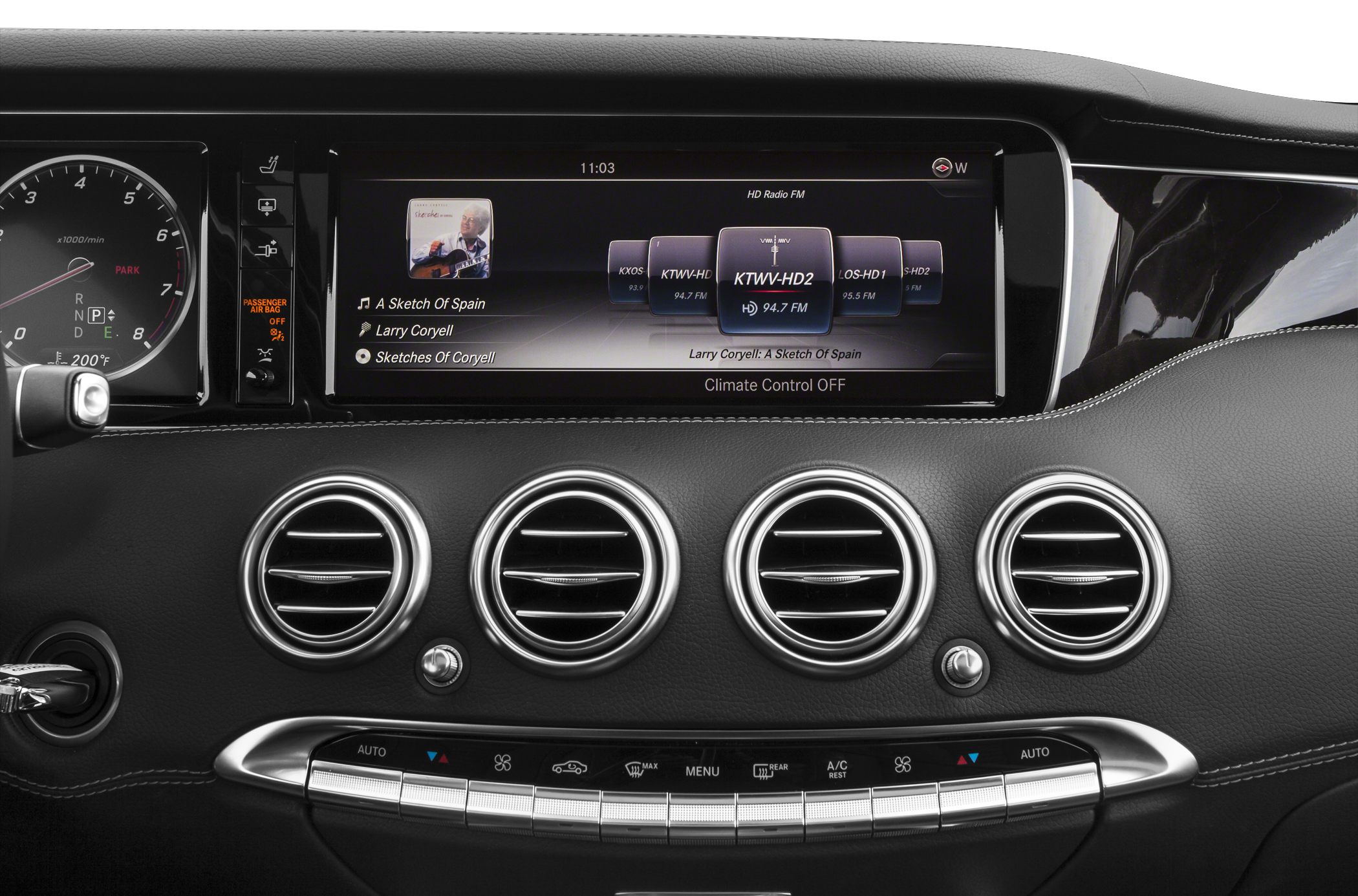 Infotainment screen and four climate control air vents on black dashboard