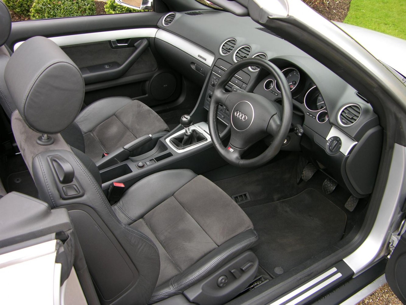 Premium convertible car interior with manual gearshift and modern dashboard