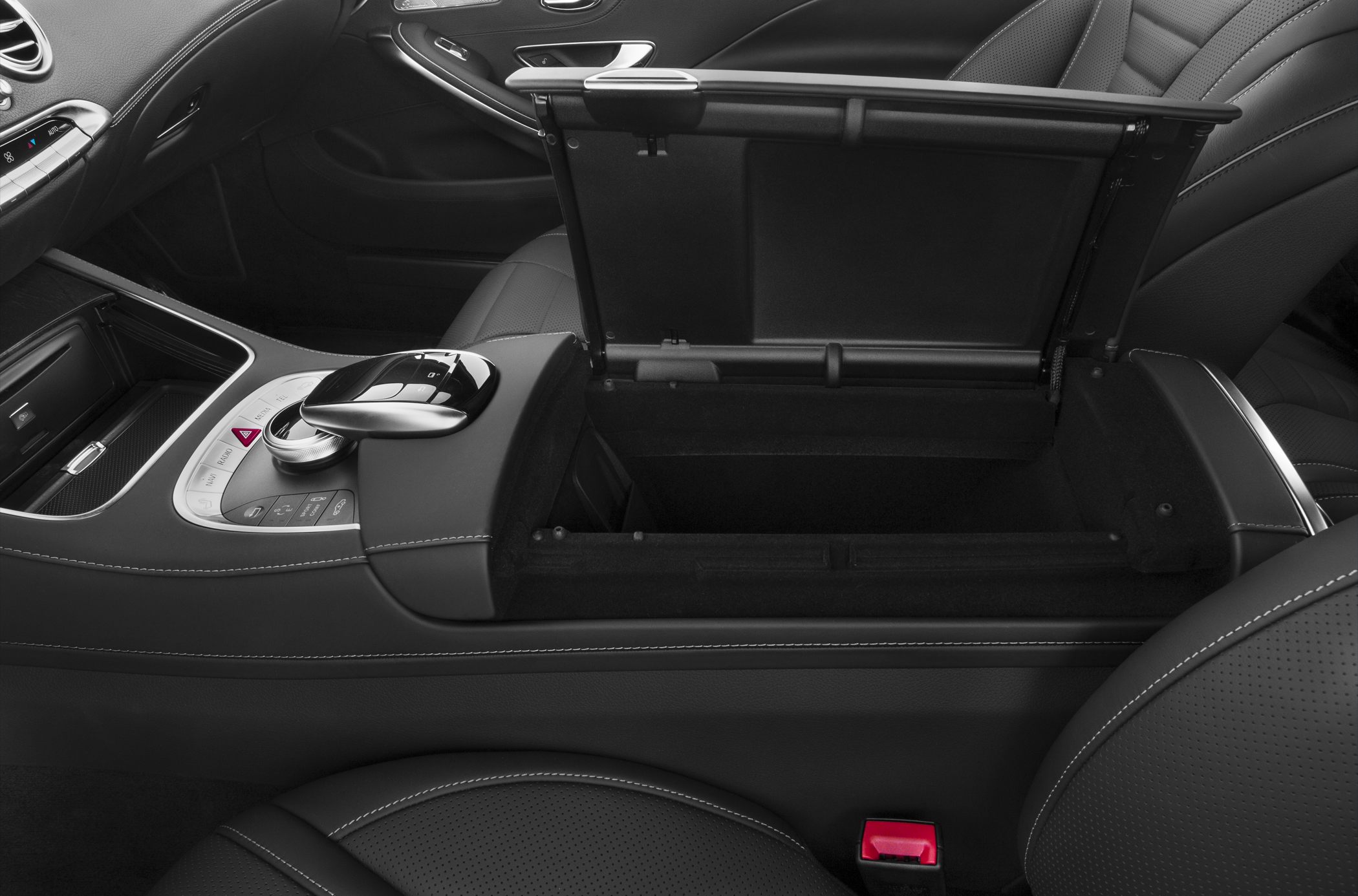Center console storage and gear selector with stitched leather upholstery