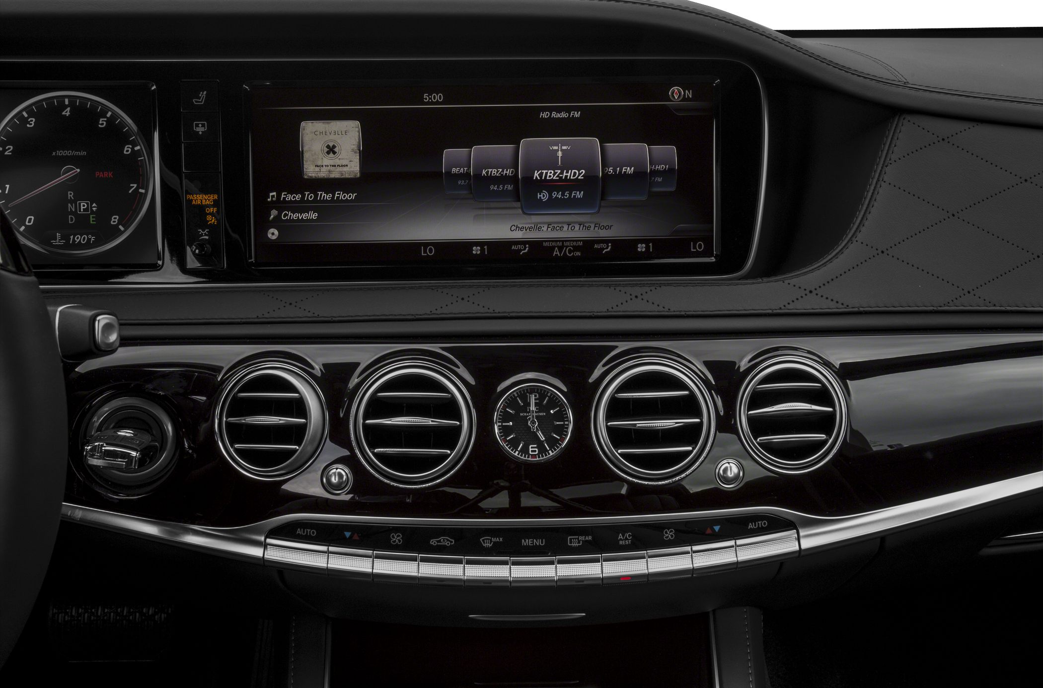 Digital instrument cluster, infotainment display, circular air vents, analog clock