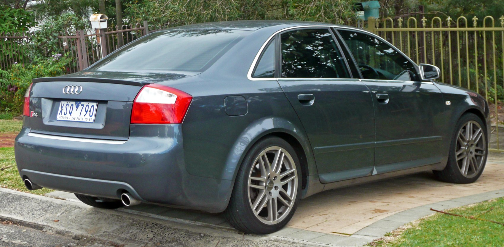 Rear-side view with dual exhaust and alloy wheels