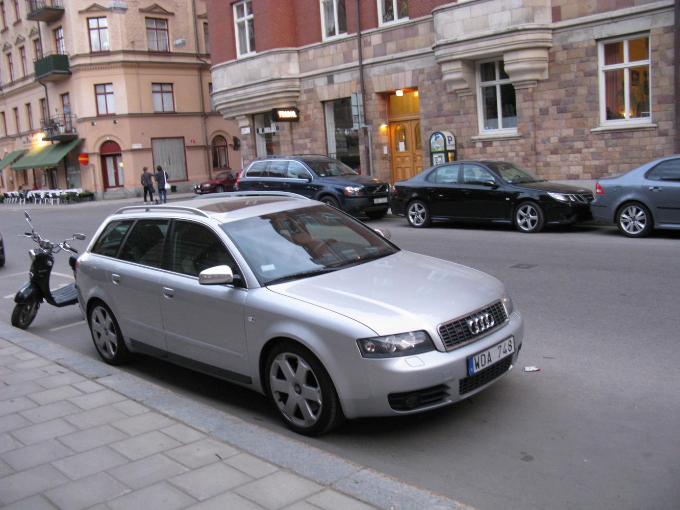 Silver station wagon showing front side and roof rails.