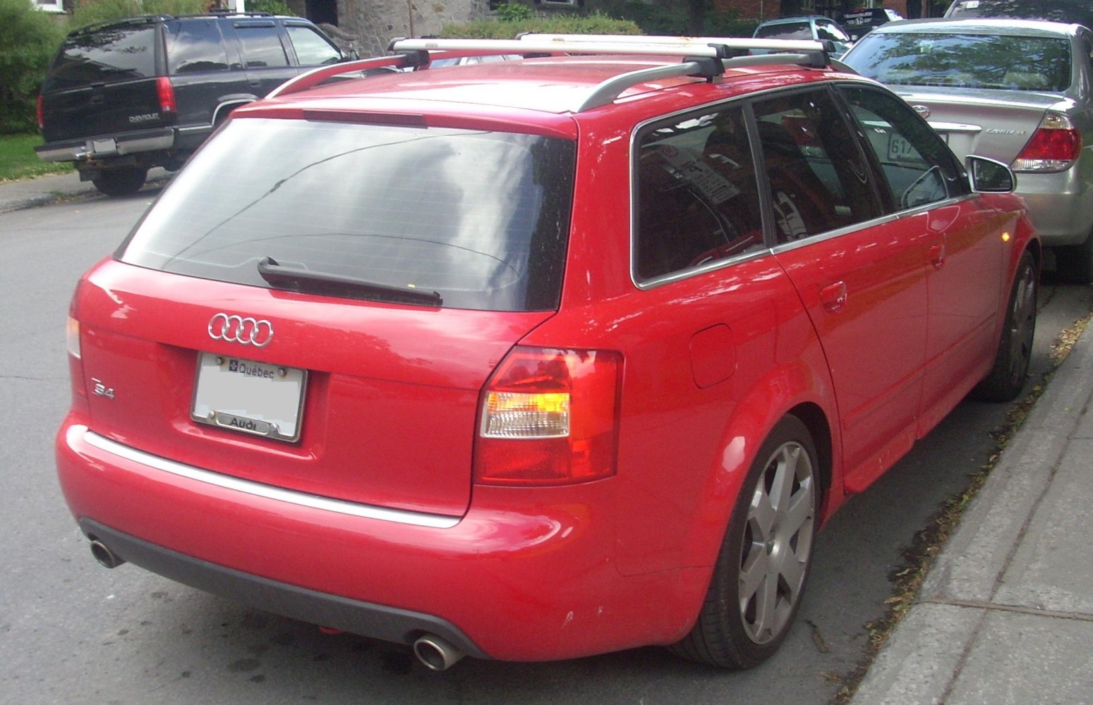 Red station wagon rear with roof rails and dual exhaust
