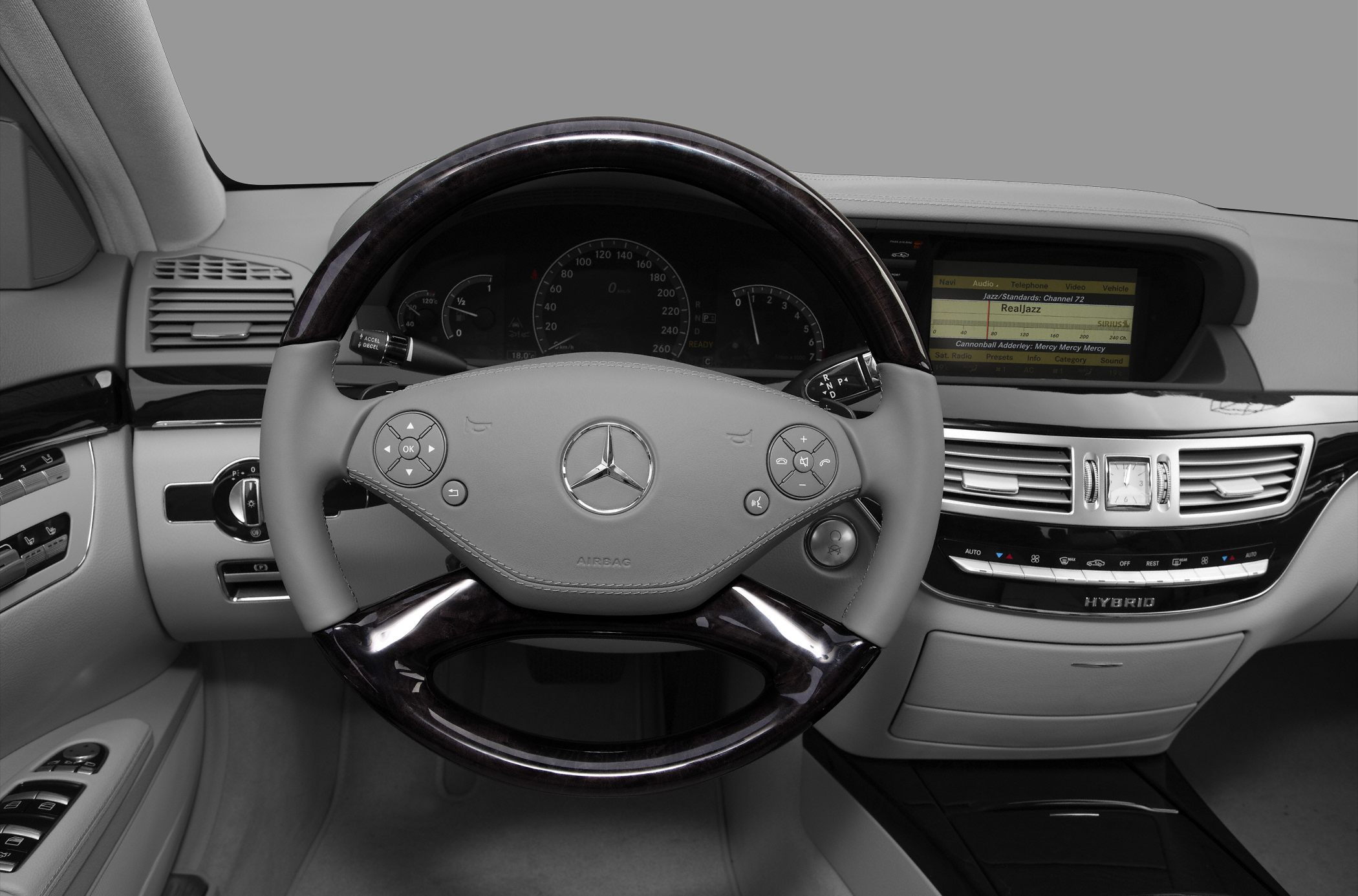 Luxury steering wheel and dashboard with multimedia display and wood trim
