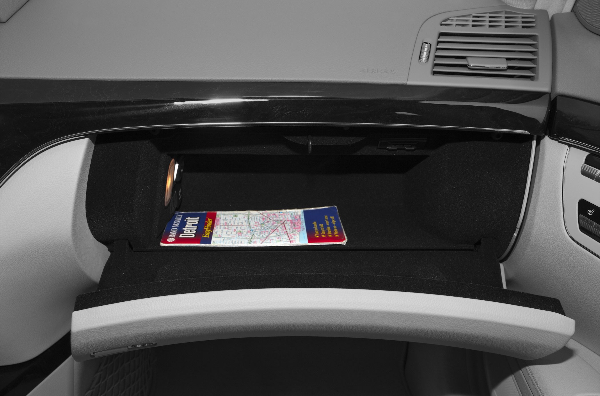 Illuminated glove compartment with map inside